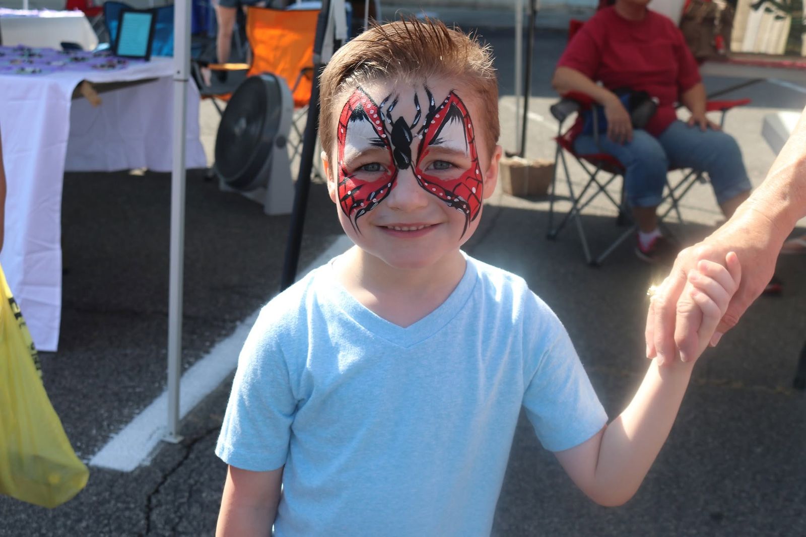 A boy showing off his butterfly face paint