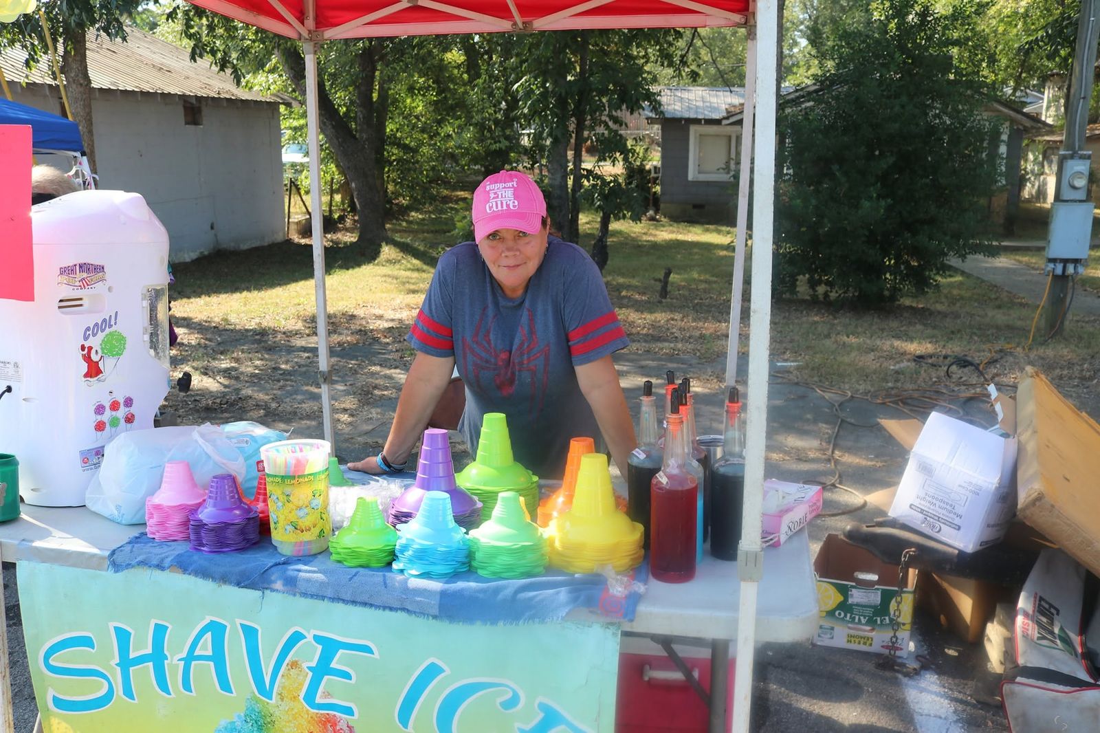 A shaved ice stand with colorful syrups